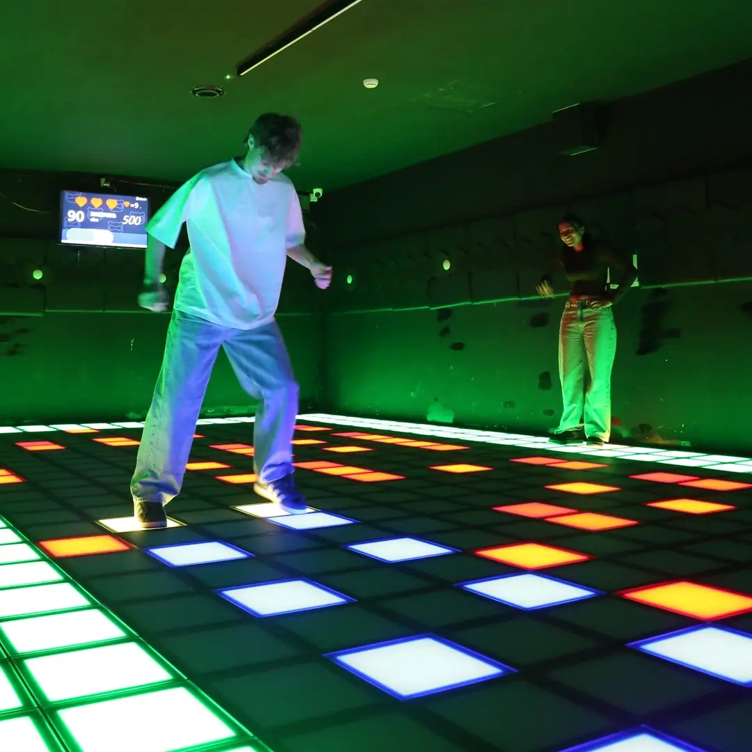 A player on the StepOn LED floor at Lucky Claw