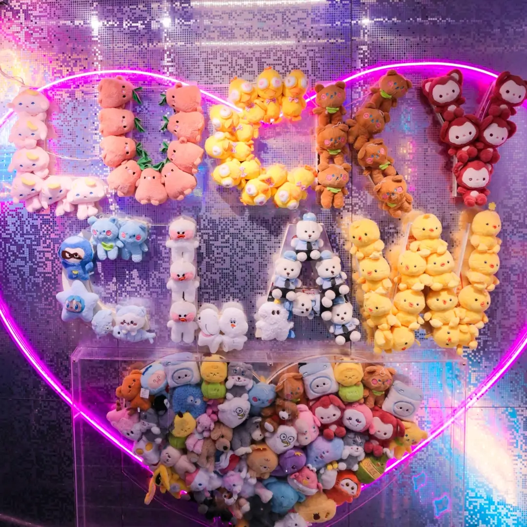 A heart-shaped wall of plushies spelling Lucky Claw